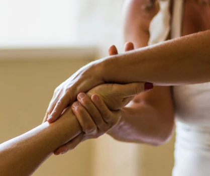 Therapist massaging a patient's wrist. 