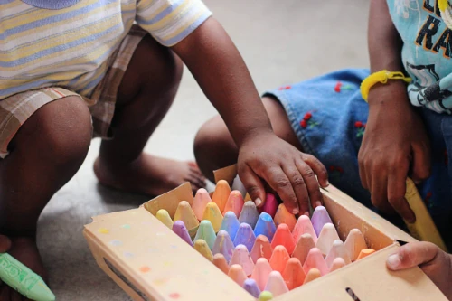 Young children with a box of giant colours