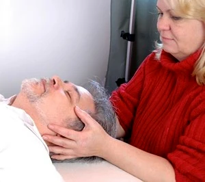 Craniosacral therapist working on a client