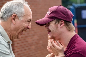 Two people grinning at eachother