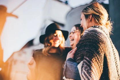 Three female friends laughing