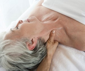 Elderly woman receiving massage therapy