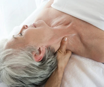 Elderly woman receiving massage therapy