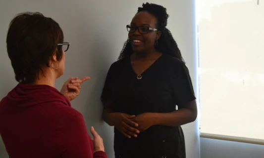 Two people having a discussion in an office.