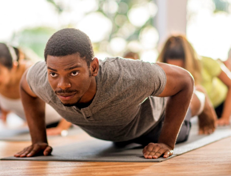 A man performing yoga in a class