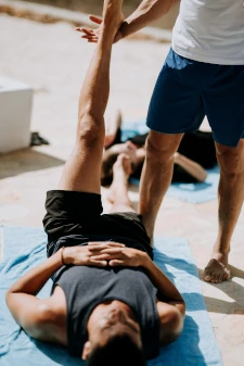 Man receiving instruction in yoga. 