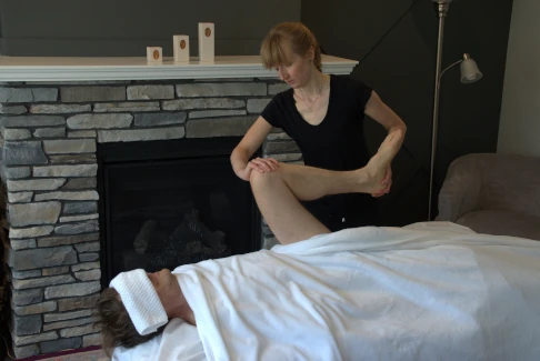 Michele Somer performing mobile massage in a client's home. 