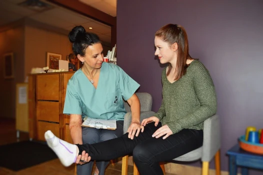 An NHPC massage therapist consults with a client