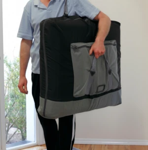 Practitioner holding a portable massage table