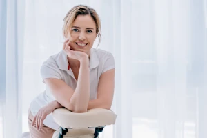 Practitioner leaning on massage chair