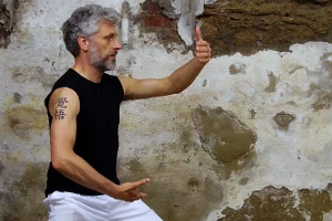 Man practising tai chi in an urban setting