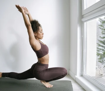 A yoga practitioner inside a snowy window. 