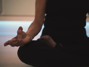 Close-up of yoga practitioner in the lotus pose.